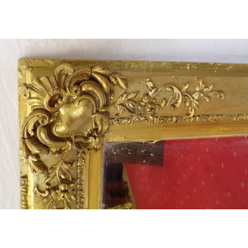 48 - Large gilt framed wall mirror with ornate scroll and foliate decoration