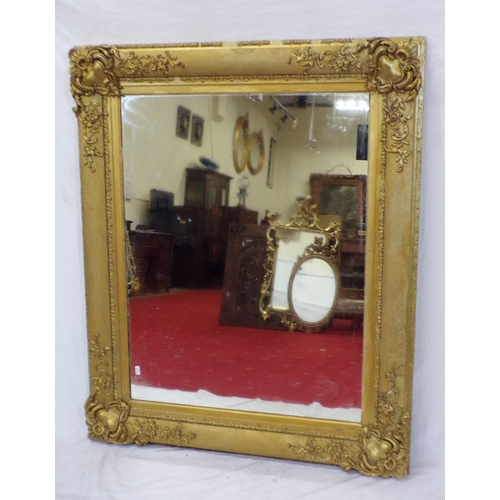 48 - Large gilt framed wall mirror with ornate scroll and foliate decoration