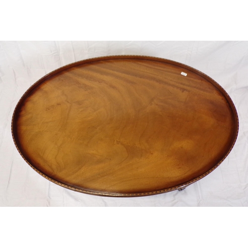 71 - Edwardian inlaid mahogany oval occasional or coffee table with raised rim, on herringbone inlaid tap... 