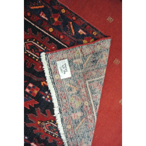 77 - Persian full pile rug with ornate foliate decoration