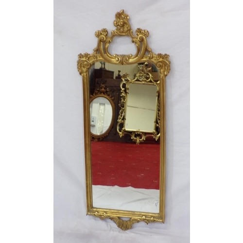 107 - Regency design gilt framed oblong wall mirror with ornate scroll and foliate decoration