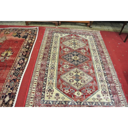 64 - Red ground full pile Kashmir carpet wth Aztec design