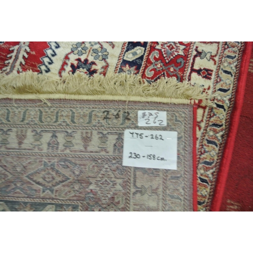 64 - Red ground full pile Kashmir carpet wth Aztec design