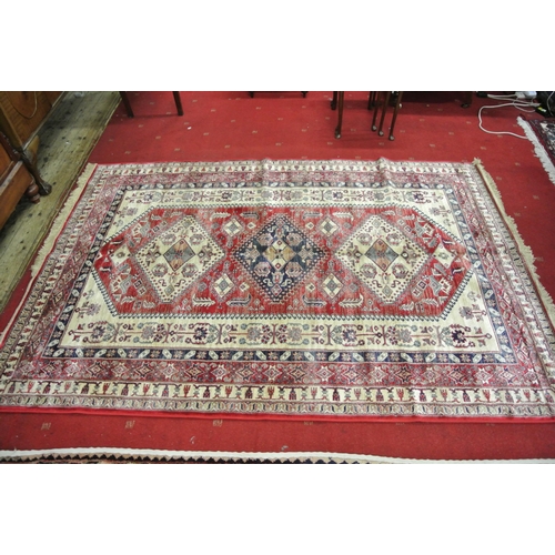 64 - Red ground full pile Kashmir carpet wth Aztec design