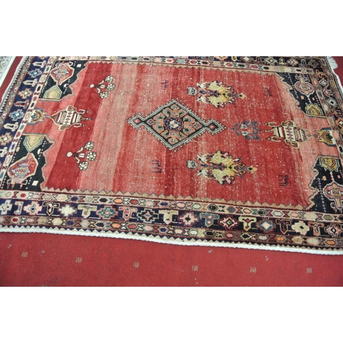 49 - Washed red ground hand woven Persian village rug with unique patterns