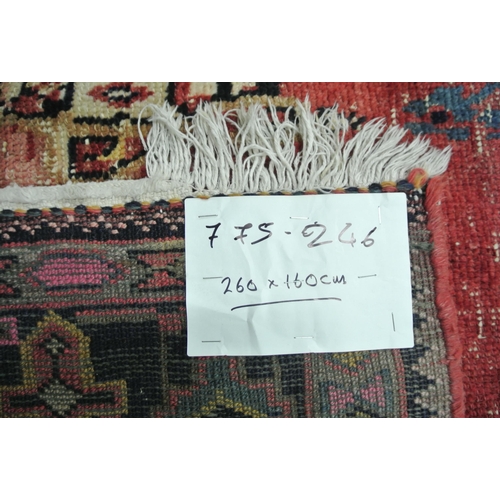 49 - Washed red ground hand woven Persian village rug with unique patterns