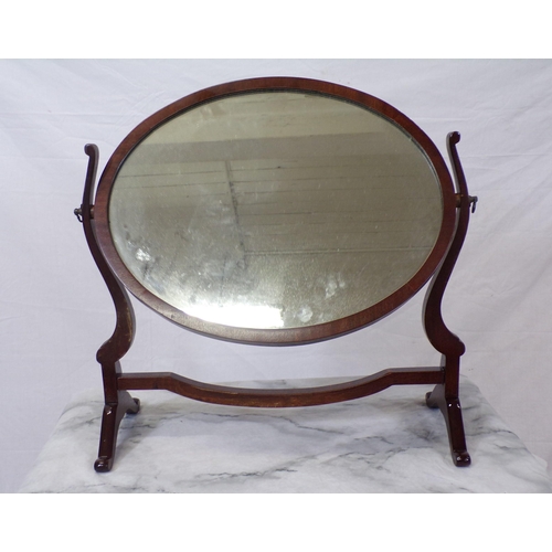 63 - Edwardian mahogany oval swivel mirror with bracket feet