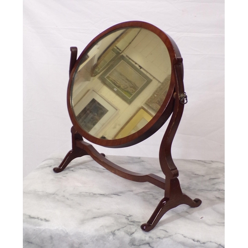 63 - Edwardian mahogany oval swivel mirror with bracket feet