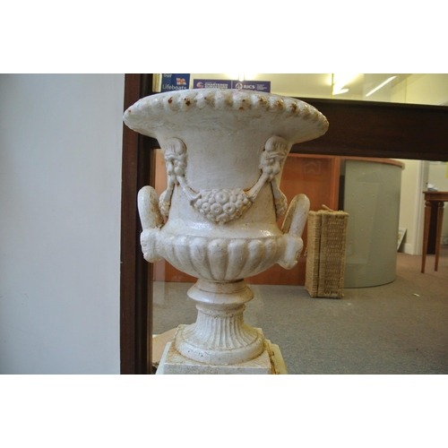 126 - Victoria style cast iron garden vase with ribbed socles, shaped handles, on foliate decorated plinth