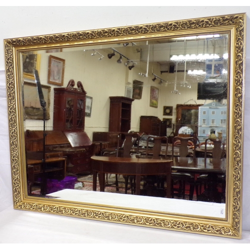 176 - Oblong bevelled glass mirror in ornate foliate decorated frame