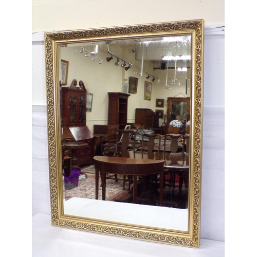 176 - Oblong bevelled glass mirror in ornate foliate decorated frame