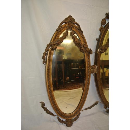 182 - Regency style triple oval bevelled mirrors with ornate foliate and scroll decorated frames