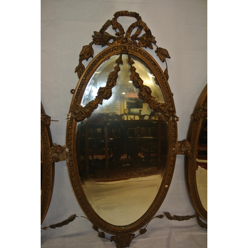 182 - Regency style triple oval bevelled mirrors with ornate foliate and scroll decorated frames