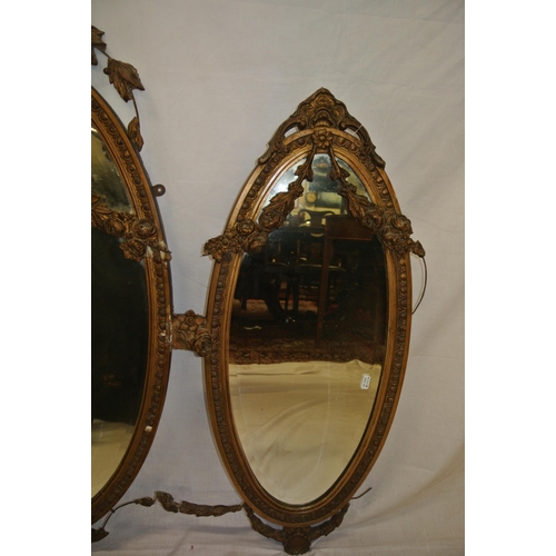 182 - Regency style triple oval bevelled mirrors with ornate foliate and scroll decorated frames