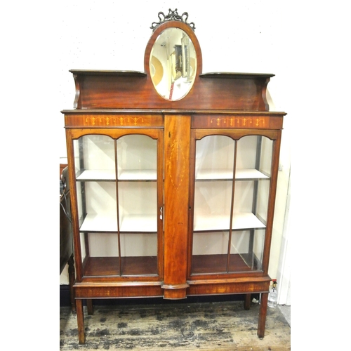 100 - Edwardian inlaid mahogany display cabinet with shaped top, oval bevelled mirror inset, glazed doors,... 