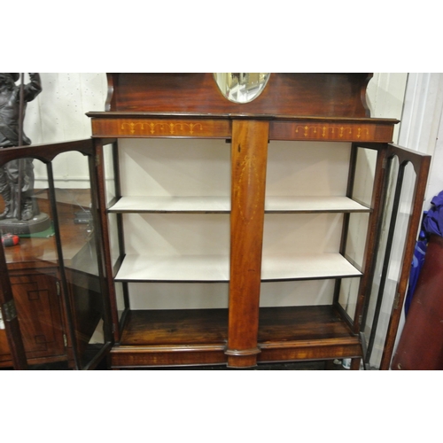 100 - Edwardian inlaid mahogany display cabinet with shaped top, oval bevelled mirror inset, glazed doors,... 