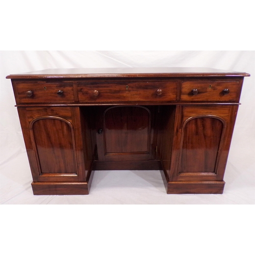 110 - Edwardian mahogany pedestal desk with three frieze drawers, shelved presses with panelled doors, on ... 