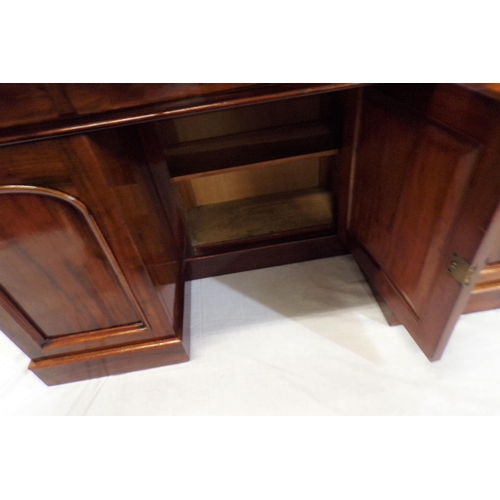 110 - Edwardian mahogany pedestal desk with three frieze drawers, shelved presses with panelled doors, on ... 