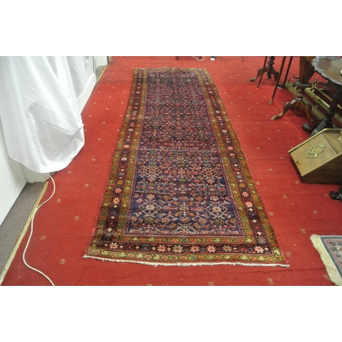 167 - Rich red ground Persian village runner 335x113cm