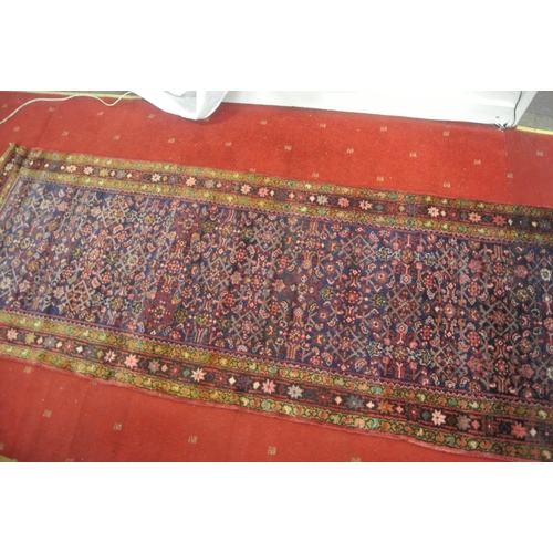 167 - Rich red ground Persian village runner 335x113cm