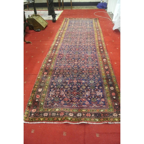 167 - Rich red ground Persian village runner 335x113cm