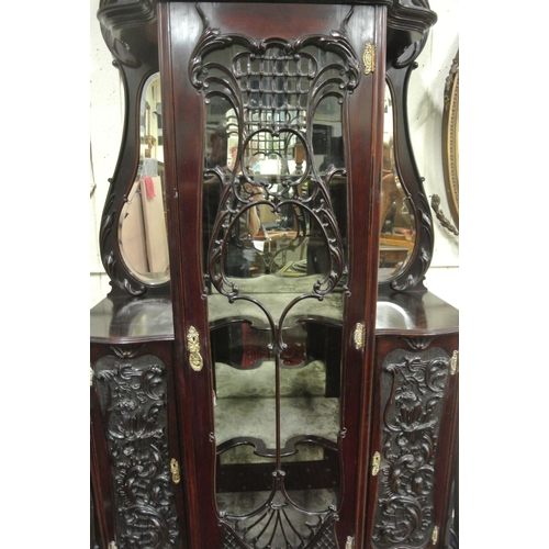 185 - Victorian mahogany display cabinet with ornate scroll decorated back, shaped bevelled mirror insets,... 