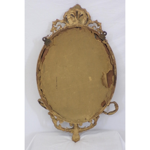 223 - Victorian gilt framed oval wall mirror with foliate decoration and sconces