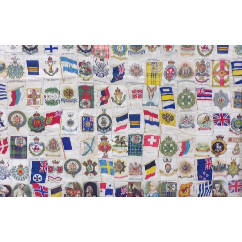 253 - Framed collection of WW1 and WW2 cigarettes silks and flags etc, 55x65cm