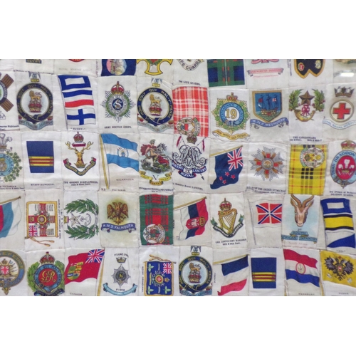 253 - Framed collection of WW1 and WW2 cigarettes silks and flags etc, 55x65cm