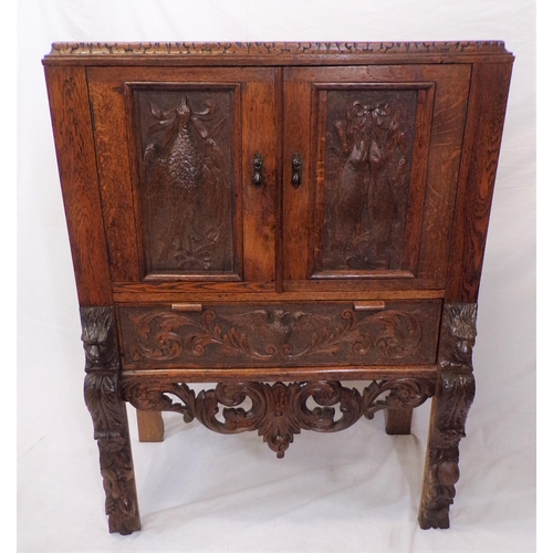 30 - Victorian oak cabinet with ornate bird decorated carved doors, frieze drawer, on carved legs