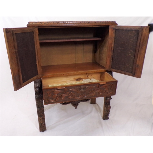 30 - Victorian oak cabinet with ornate bird decorated carved doors, frieze drawer, on carved legs