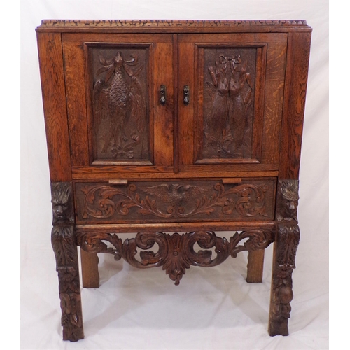 30 - Victorian oak cabinet with ornate bird decorated carved doors, frieze drawer, on carved legs