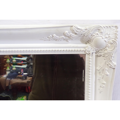 32 - Large bevelled glass wall mirror with foliate decorated frame