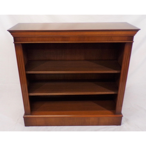 86 - Edwardian yew bookcase with reeded adjustable  shelving, on oblong base