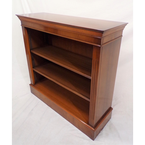 86 - Edwardian yew bookcase with reeded adjustable  shelving, on oblong base