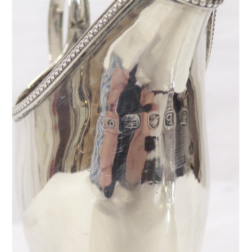 230 - George III London silver helmet shaped cream jug with beaded rim, shaped handle, on raised base 106g