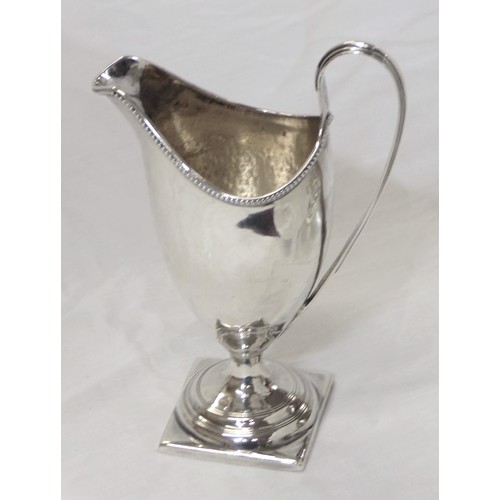 230 - George III London silver helmet shaped cream jug with beaded rim, shaped handle, on raised base 106g