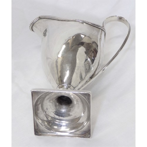 230 - George III London silver helmet shaped cream jug with beaded rim, shaped handle, on raised base 106g