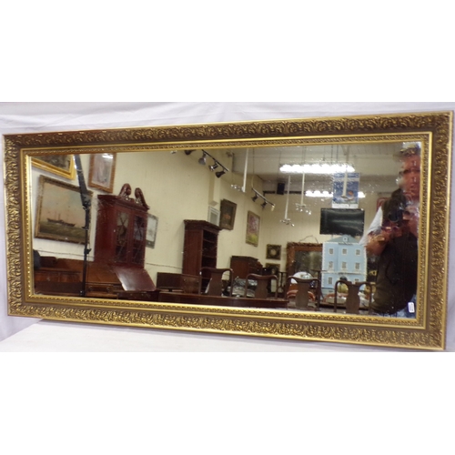 133 - Oblong wall mirror with foliate decorated frame