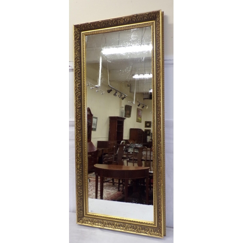 133 - Oblong wall mirror with foliate decorated frame