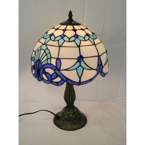 197 - Ornate bronzed electric table lamp with blue and white multi-coloured faceted shade