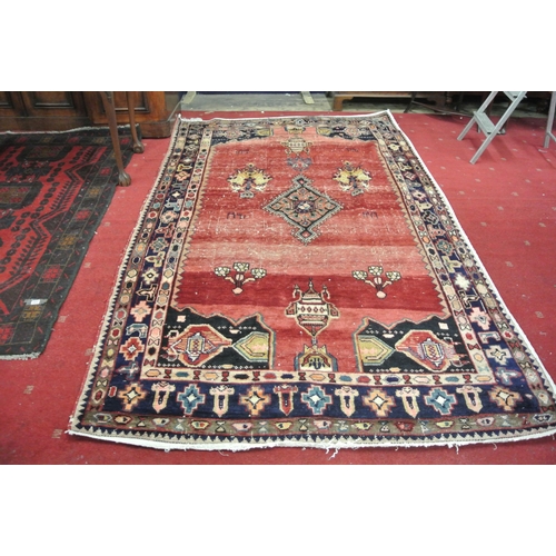 231 - Washed red ground hand woven Persian village rug with unique patterns