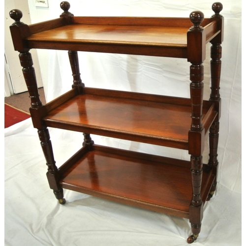 130 - Victorian mahogany three tier dumbwaiter with raised gallery, turned finials and rails, on castors