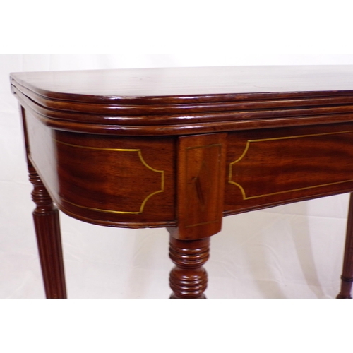 135 - Edwardian mahogany card table with fold-over top, reeded borders, gateleg support, on reeded taperin... 