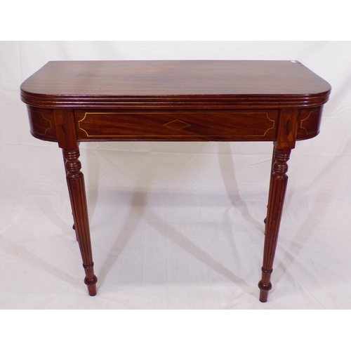 135 - Edwardian mahogany card table with fold-over top, reeded borders, gateleg support, on reeded taperin... 