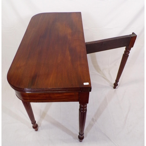 135 - Edwardian mahogany card table with fold-over top, reeded borders, gateleg support, on reeded taperin... 