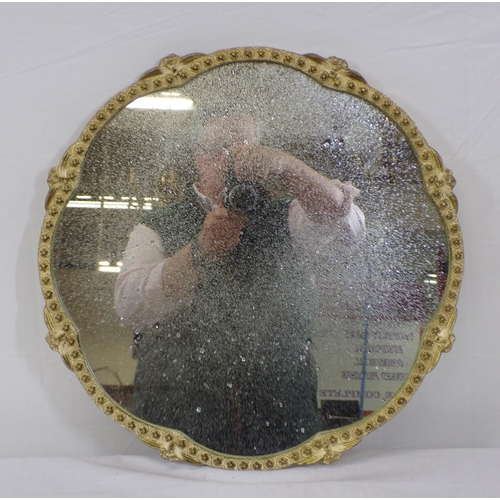 22 - Oval glass wall mirror with shaped decorated frame