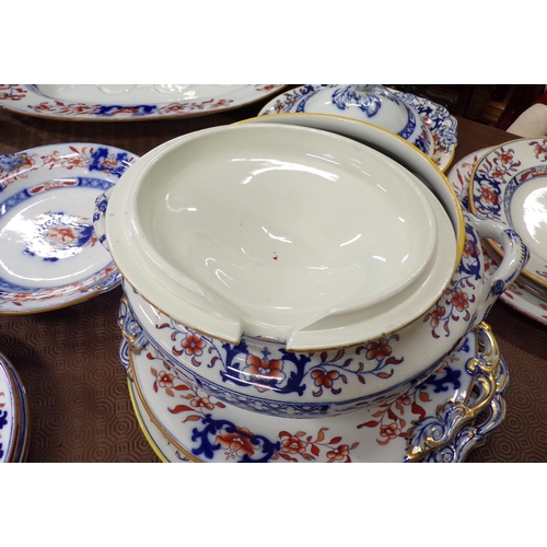 82 - Thirty eight piece assorted Ironstone dinner service with ornate foliate decoration