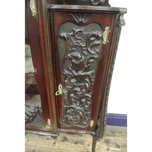 195 - Victorian mahogany display cabinet with ornate scroll decorated back, shaped bevelled mirror insets,... 