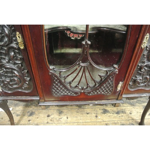 195 - Victorian mahogany display cabinet with ornate scroll decorated back, shaped bevelled mirror insets,... 